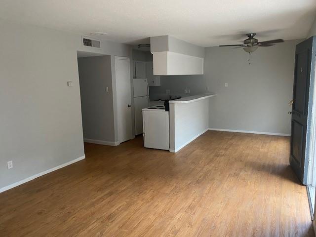 a kitchen with a wooden floor and a stove