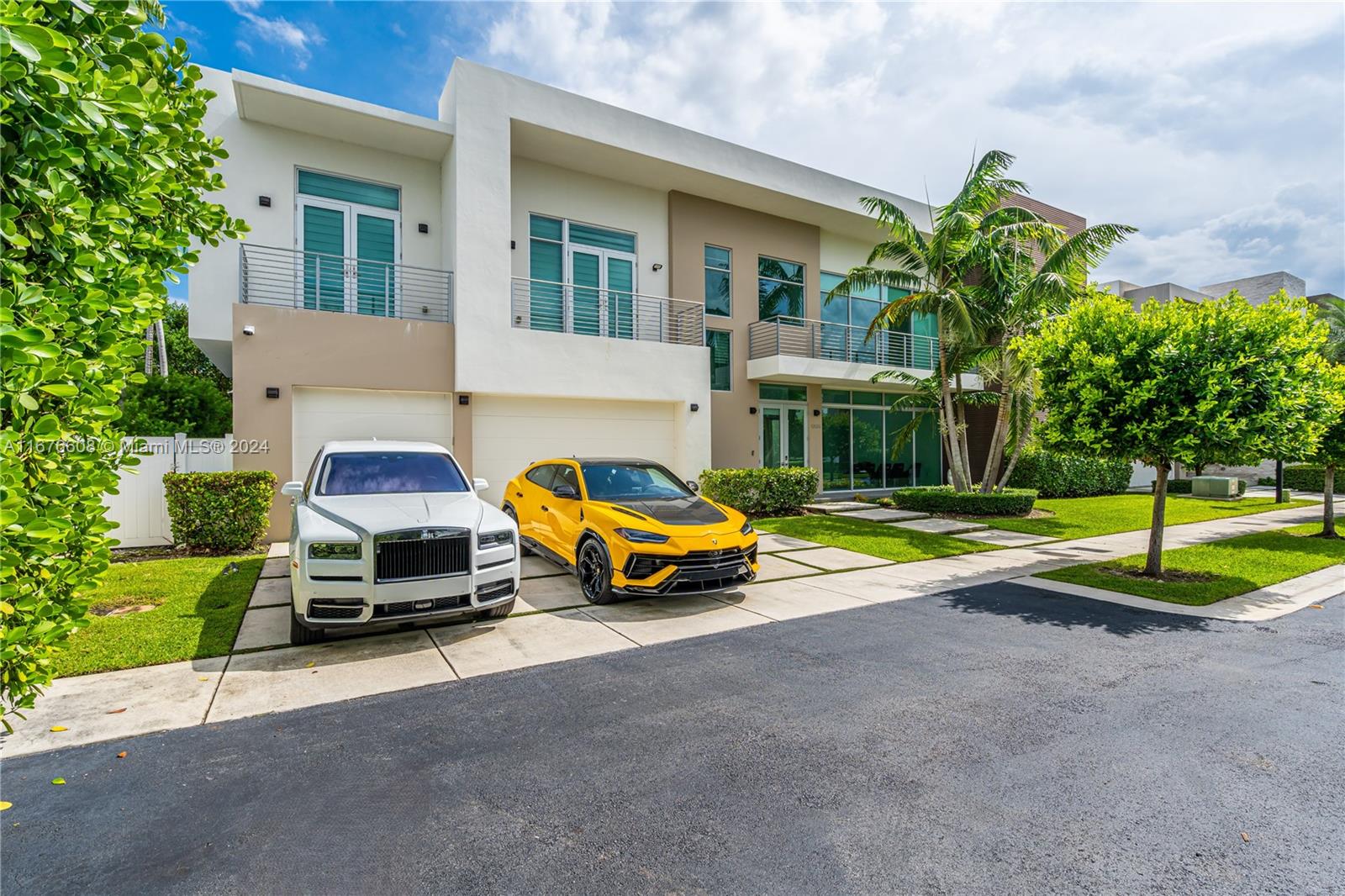 a car parked in front of a house with a yard