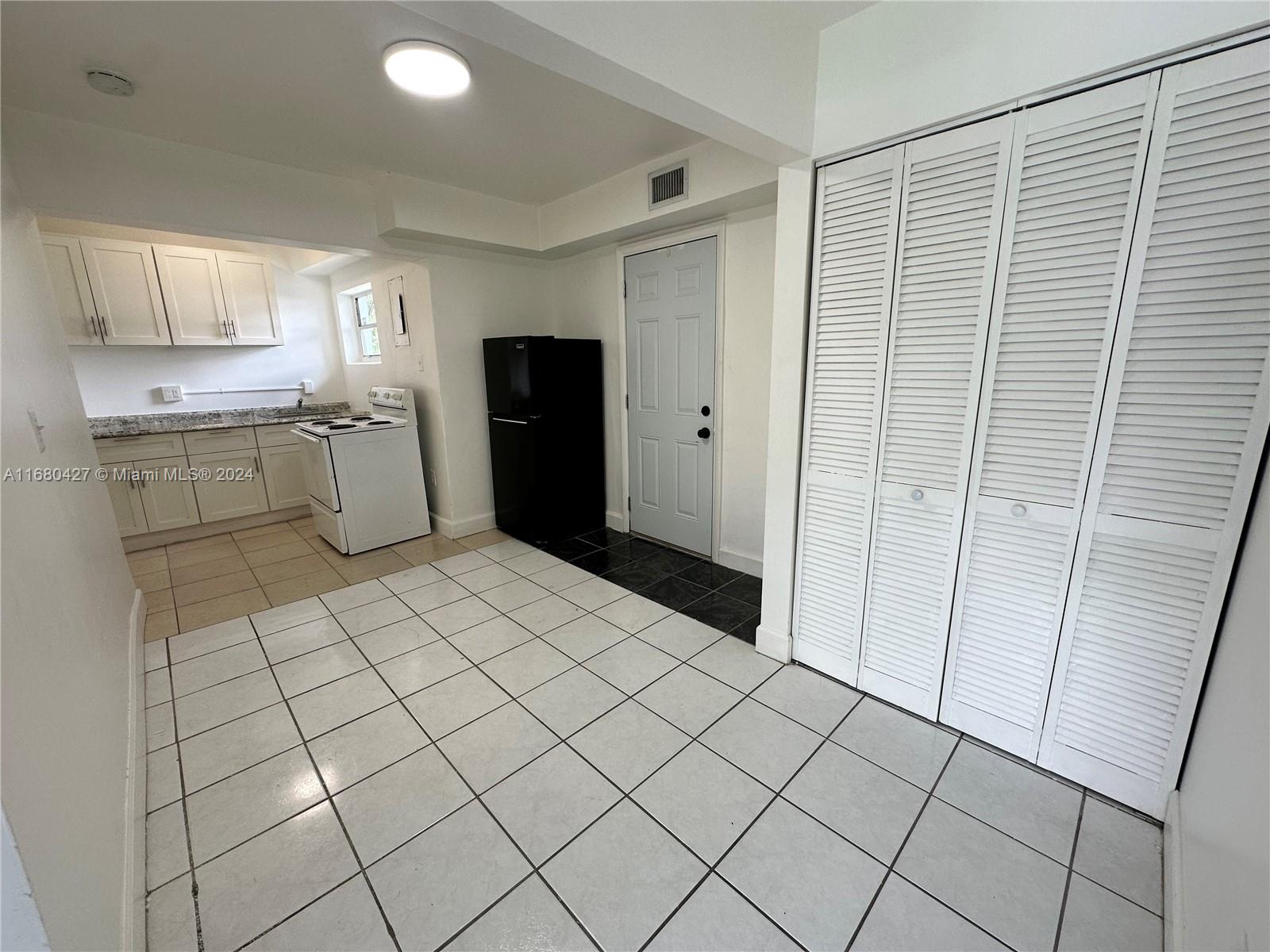 a room with a washing machine and cabinets