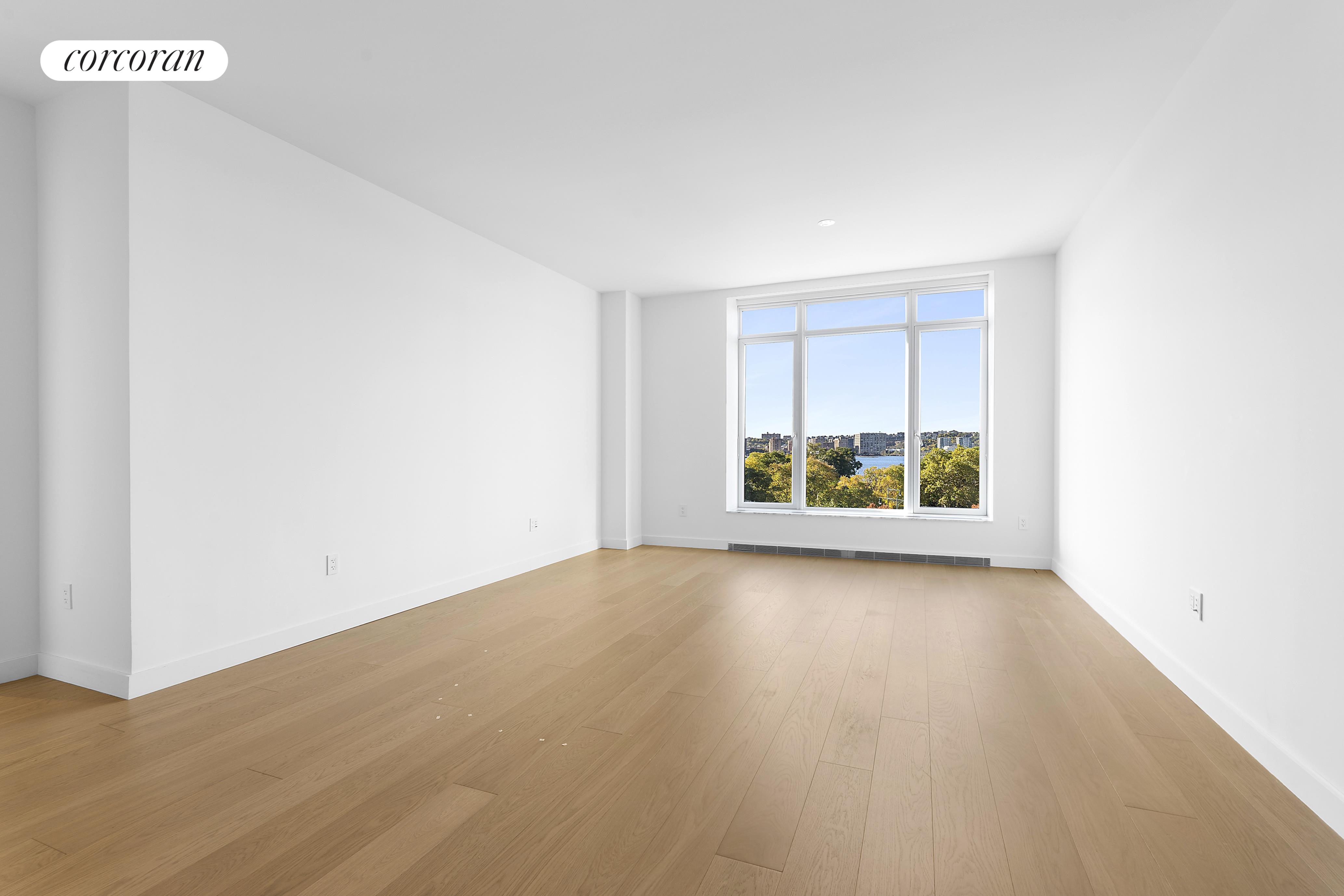 a view of a room with wooden floor and window