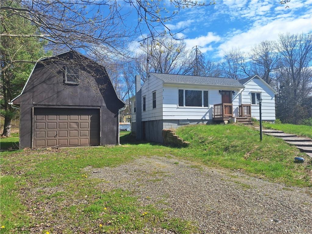 a front view of house with yard and trees