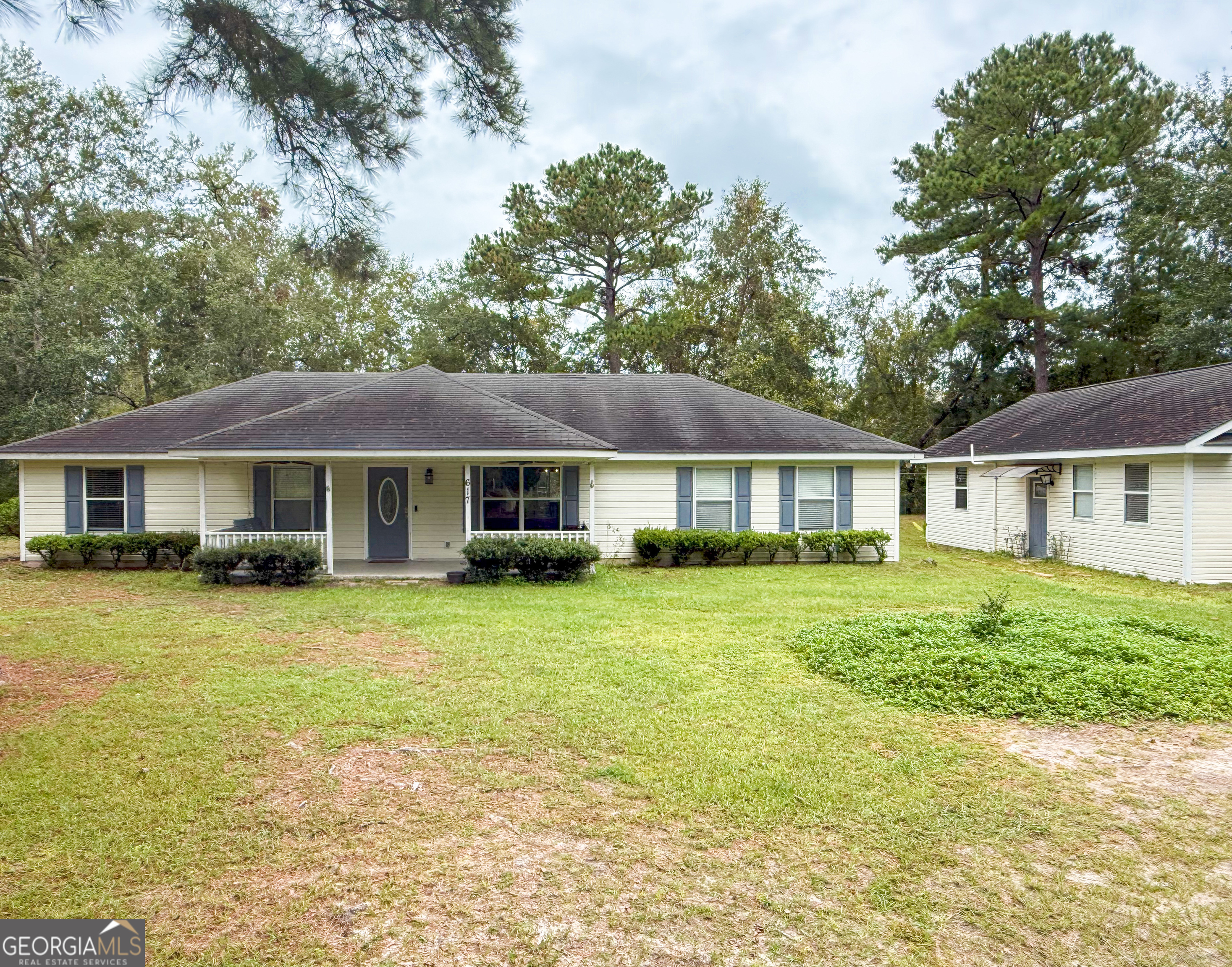 a front view of a house with a garden