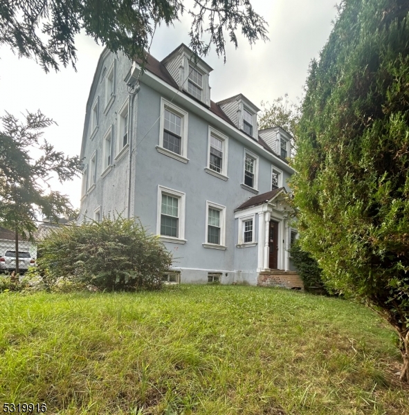 a front view of house with yard and green space