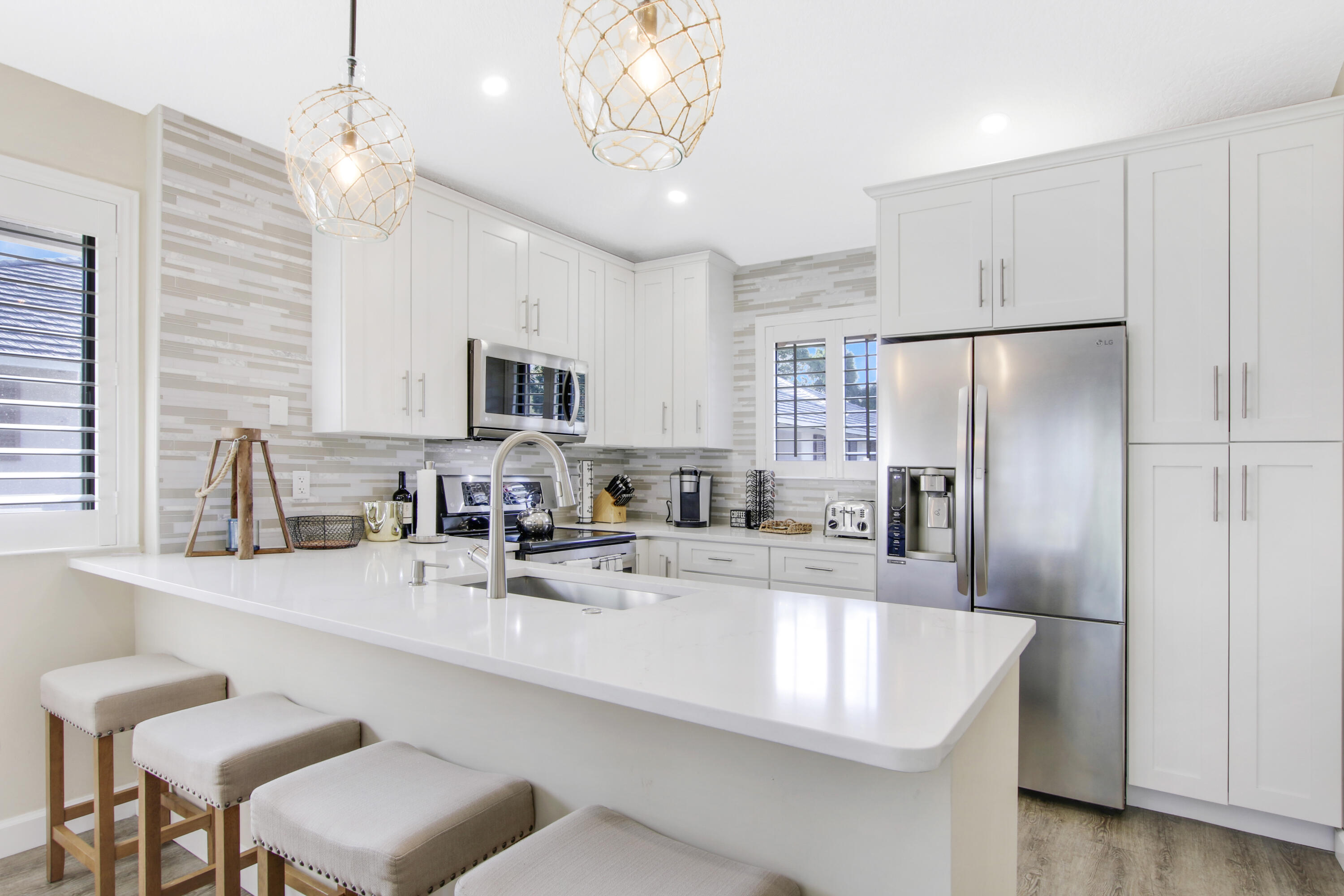 a large kitchen with granite countertop a sink stainless steel appliances and cabinets