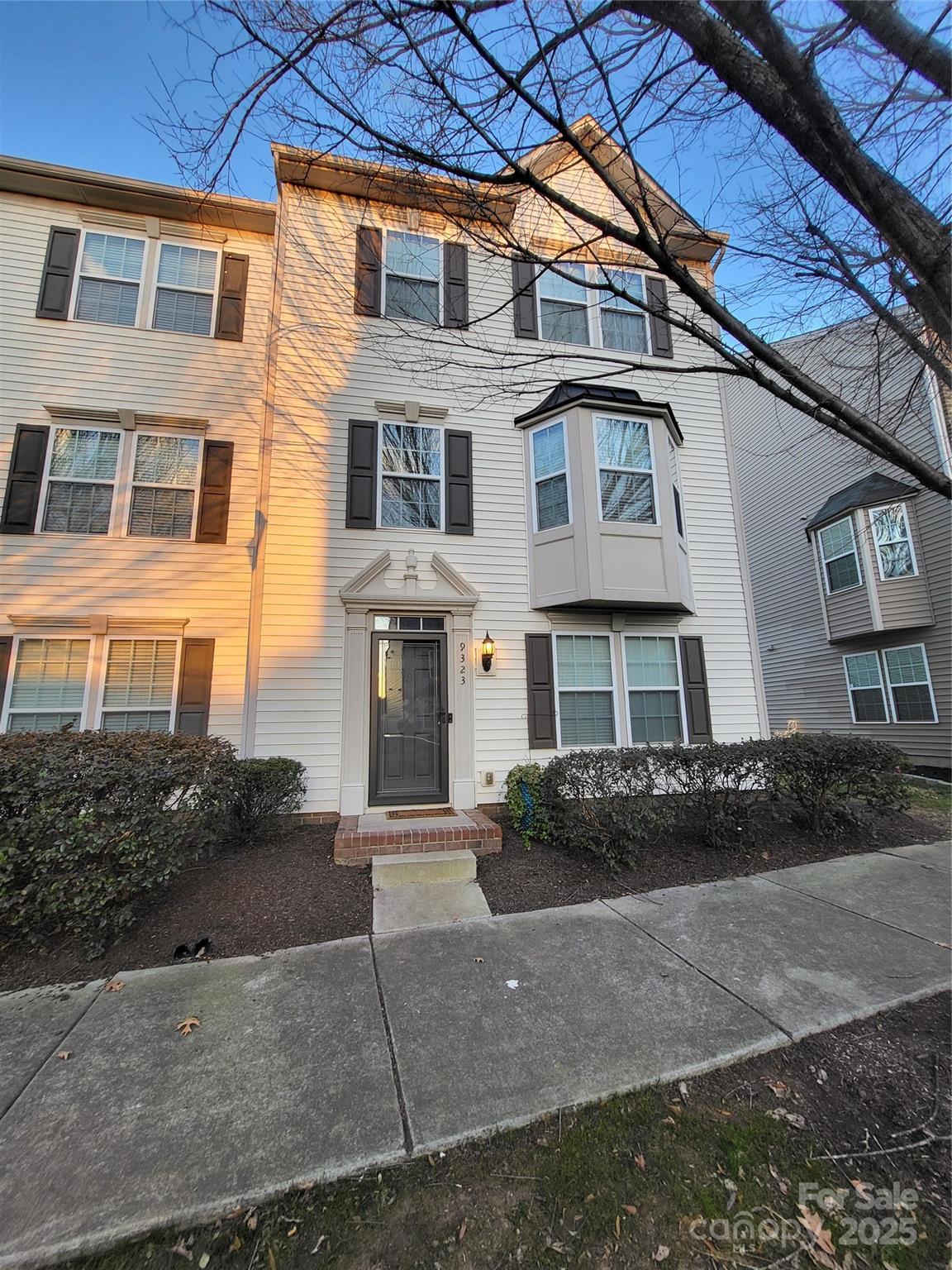 a front view of a residential apartment building with a yard