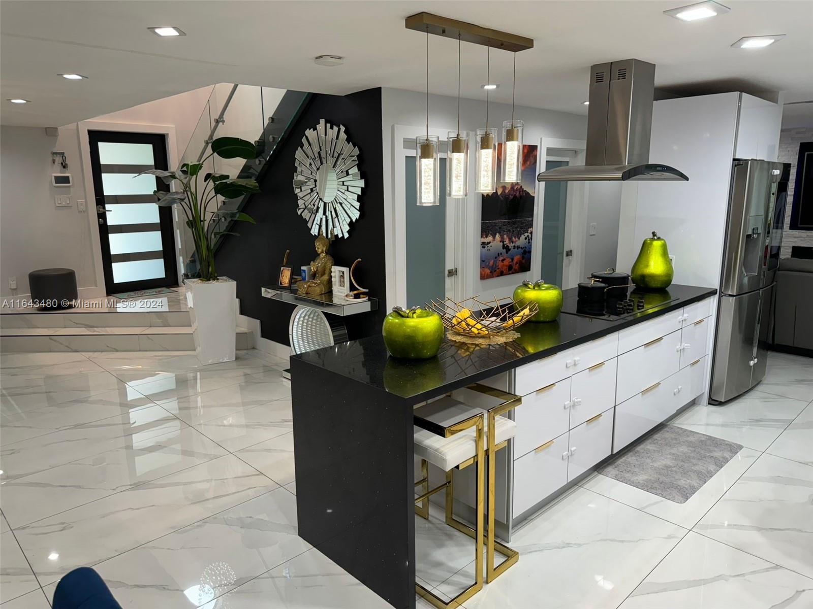 a kitchen with counter top space cabinets and chandelier