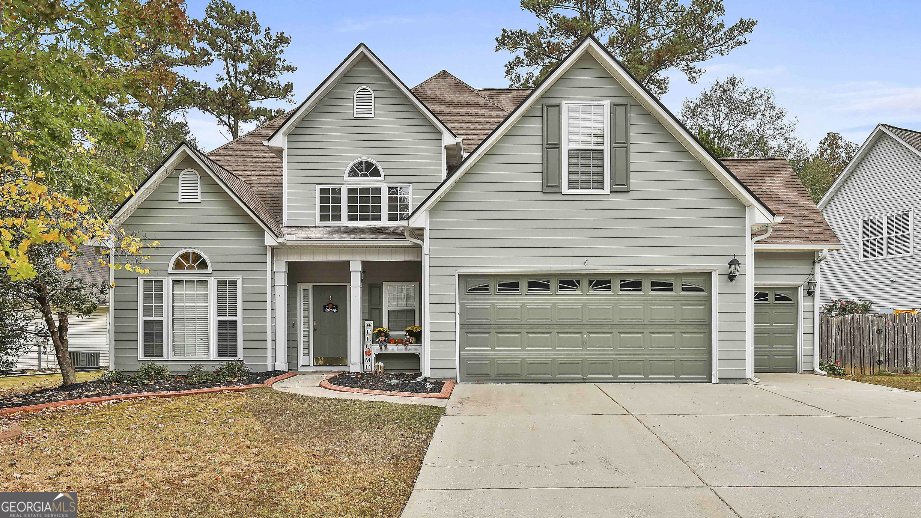 a front view of a house with a yard and garage