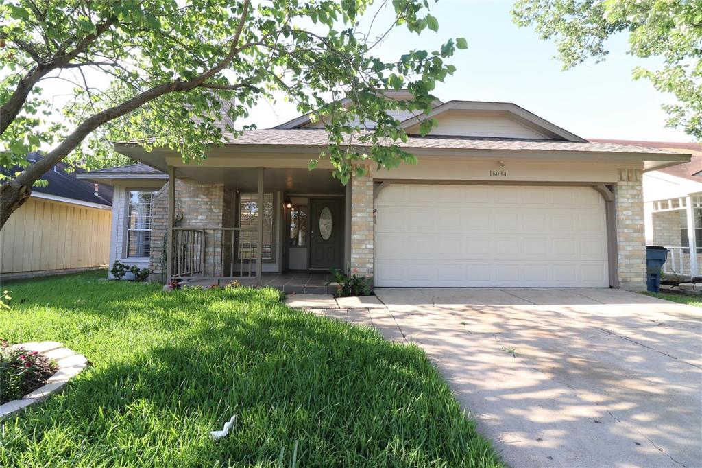 a front view of a house with a garden and yard