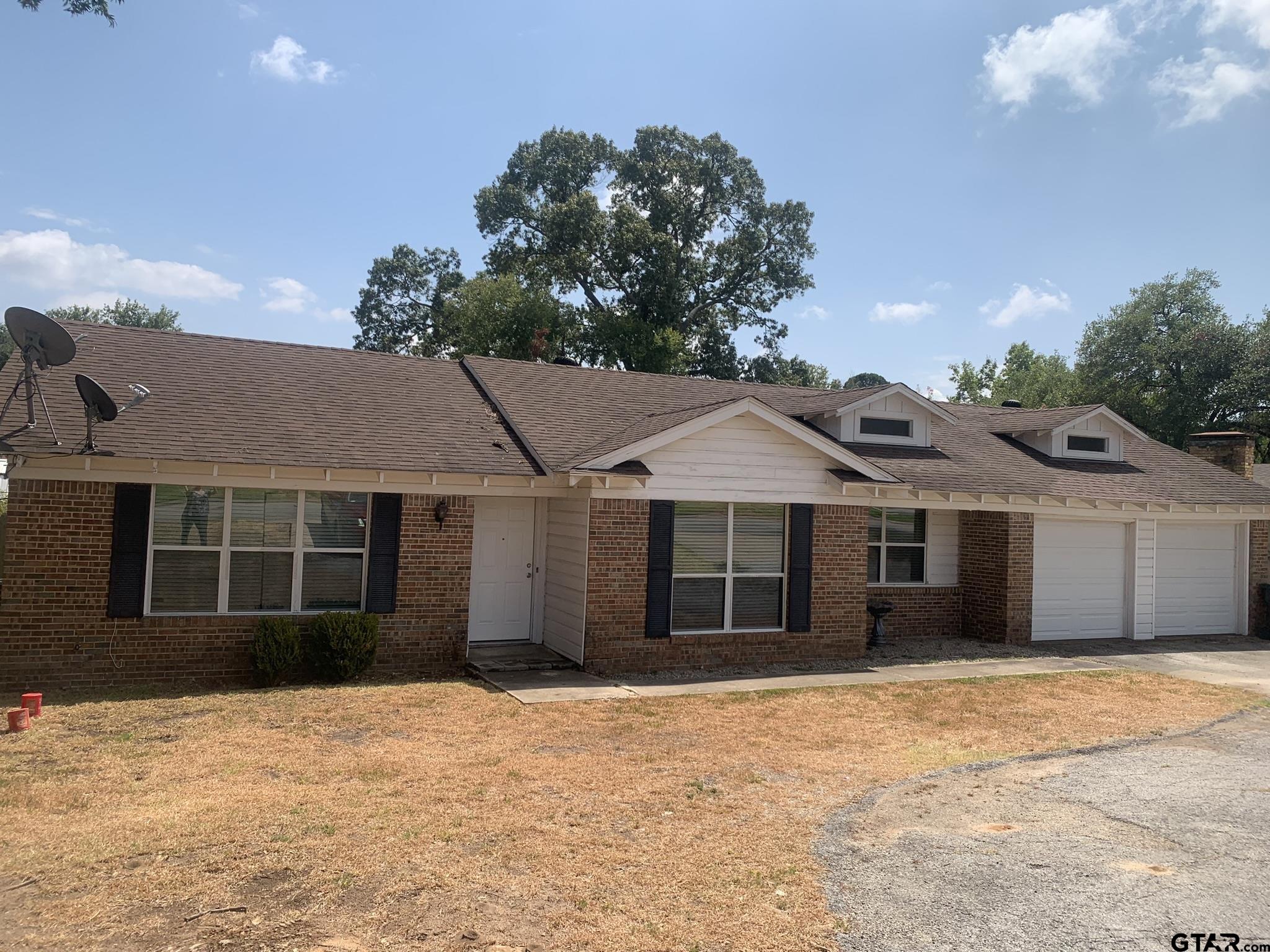 front view of a house with a yard