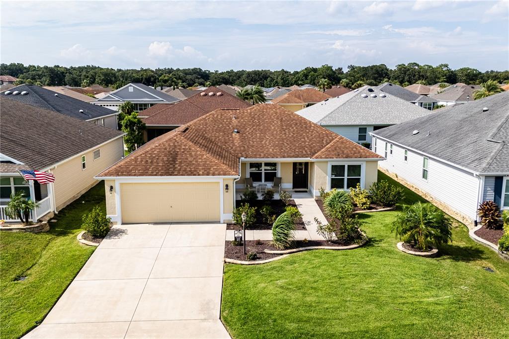 an aerial view of a house with yard