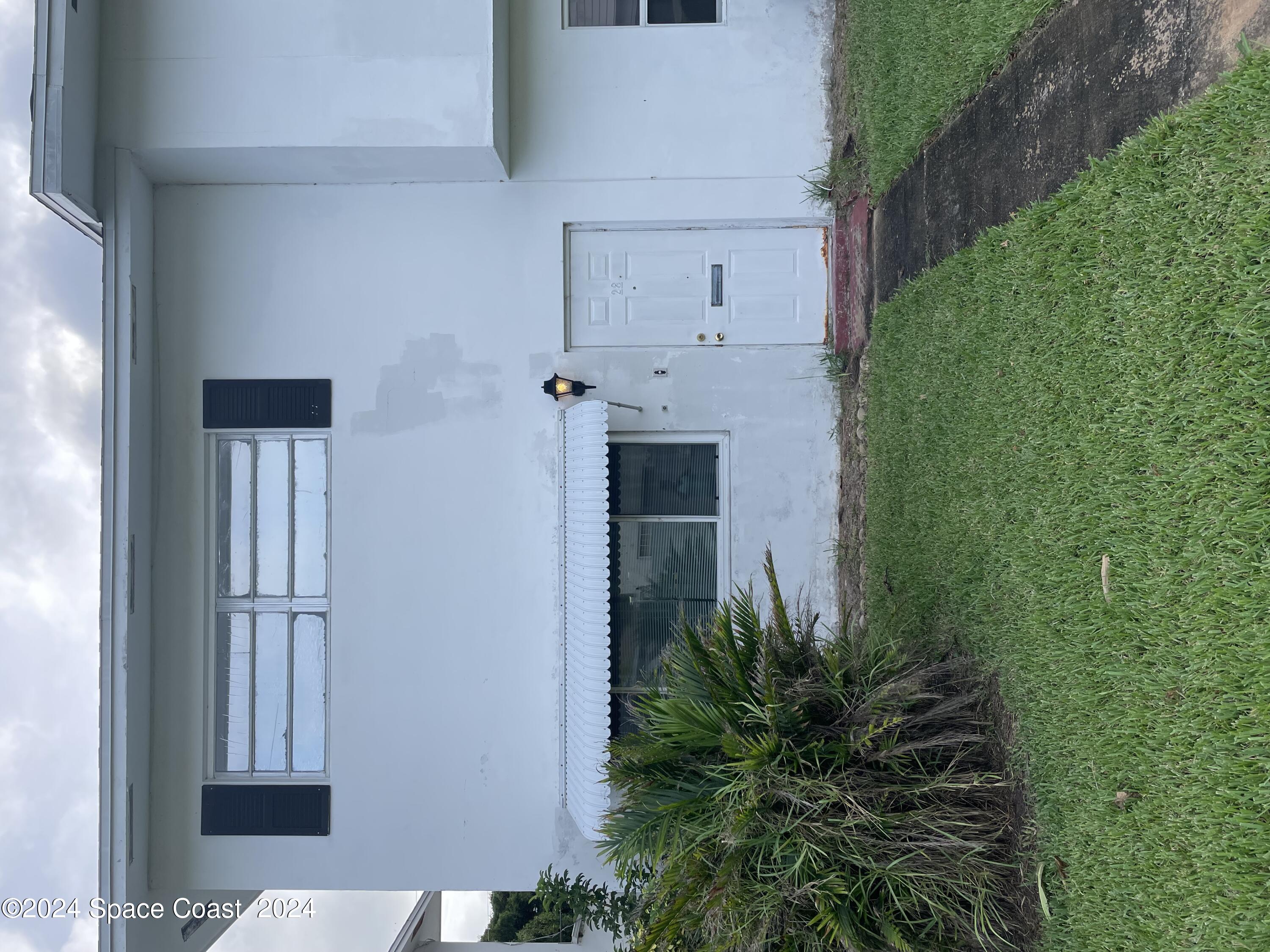 a backyard of a house with lots of green space and plants