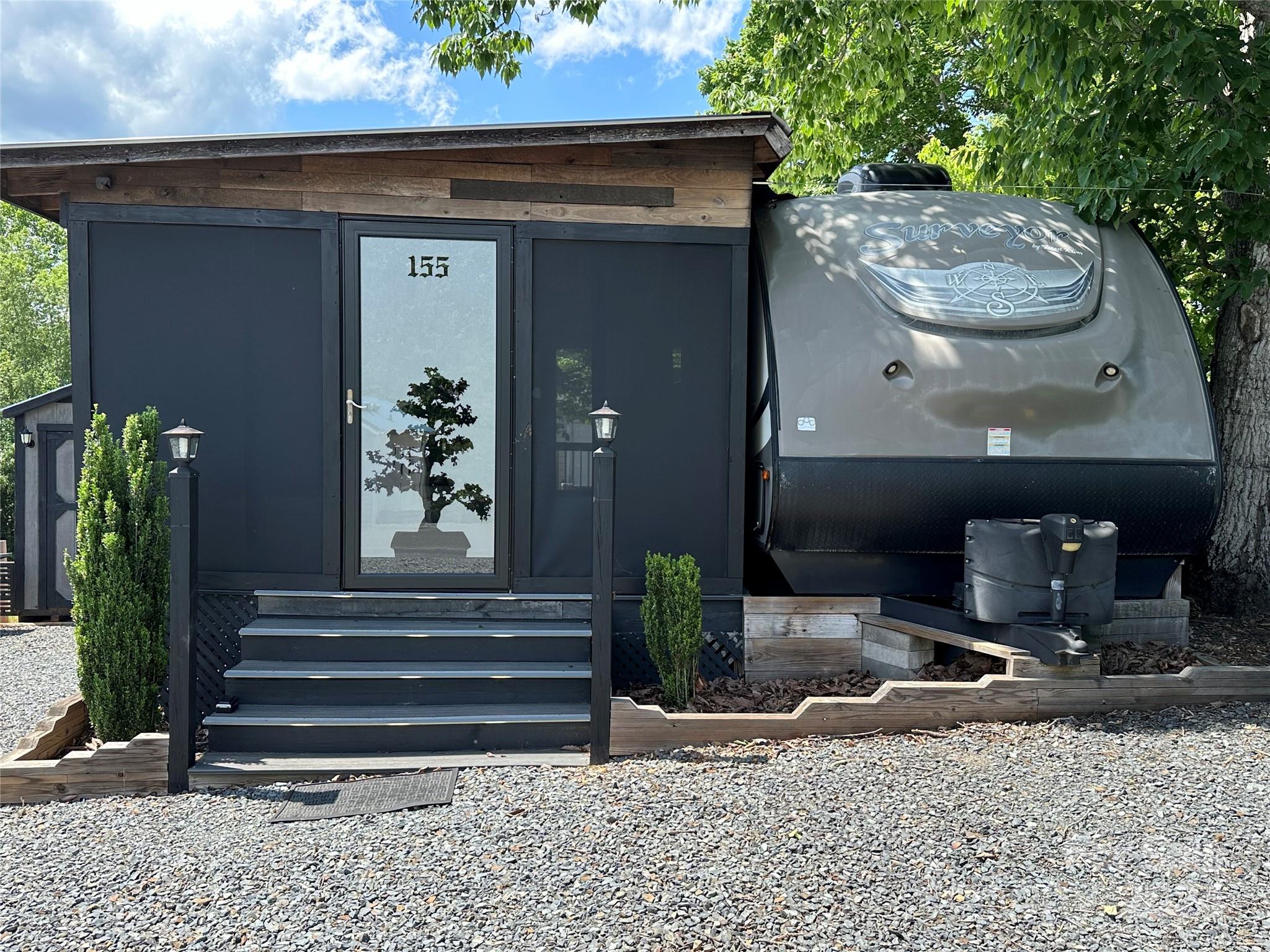 a front view of a house with plants