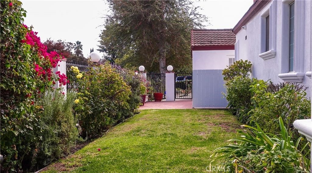 a view of a house with a backyard and pathway