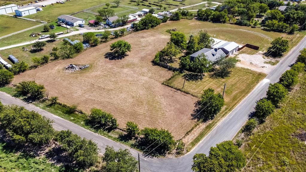 an aerial view of a house with a yard and lake view