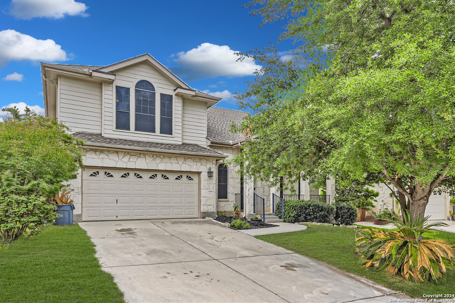 a front view of a house with a garden