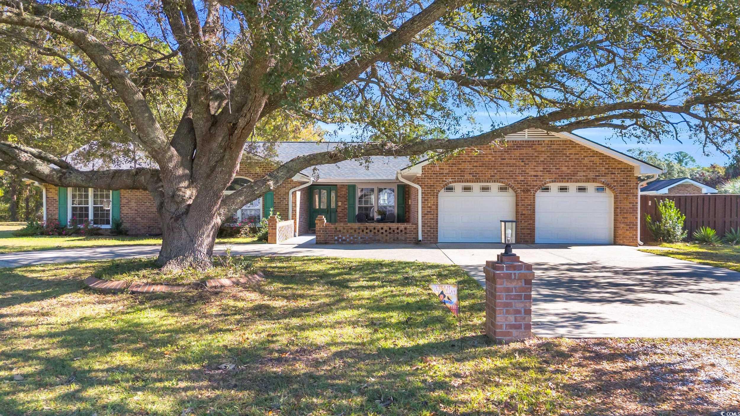 Ranch-style home featuring a front lawn and a gara