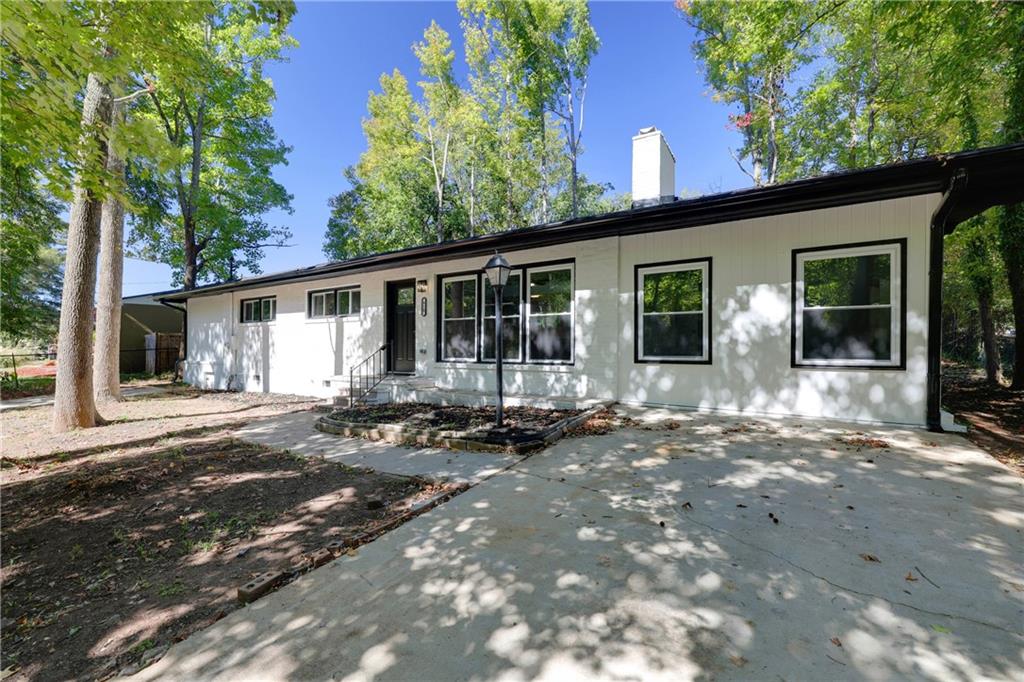 a view of a house with backyard sitting area and porch