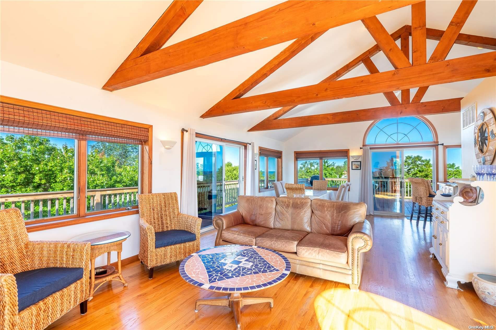 a living room with patio furniture and a large window