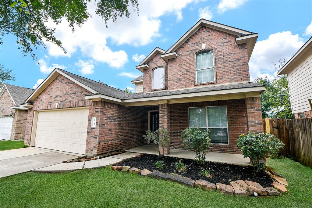 a front view of a house with a garden and plants