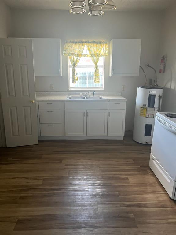 a view of a kitchen with wooden floor and a sink