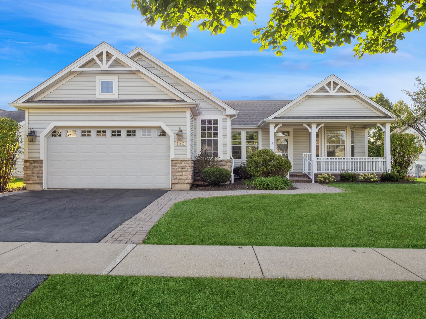 a front view of a house with a garden