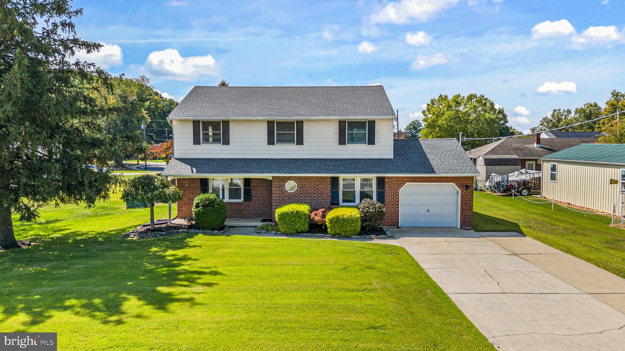 a front view of house with yard and outdoor seating