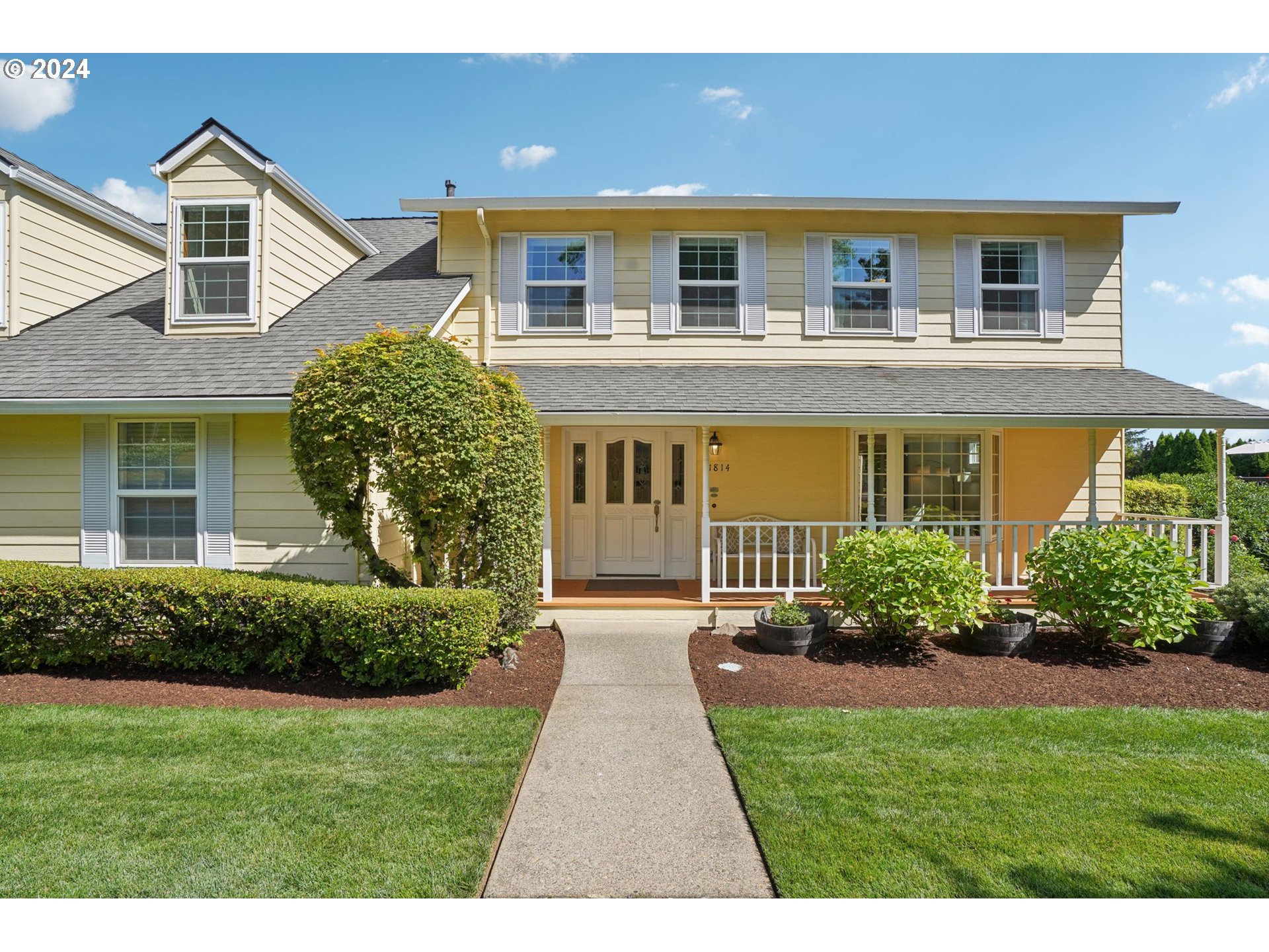 a front view of a house with a yard