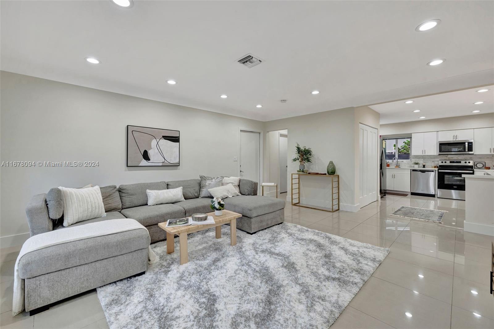 a living room with furniture and kitchen view