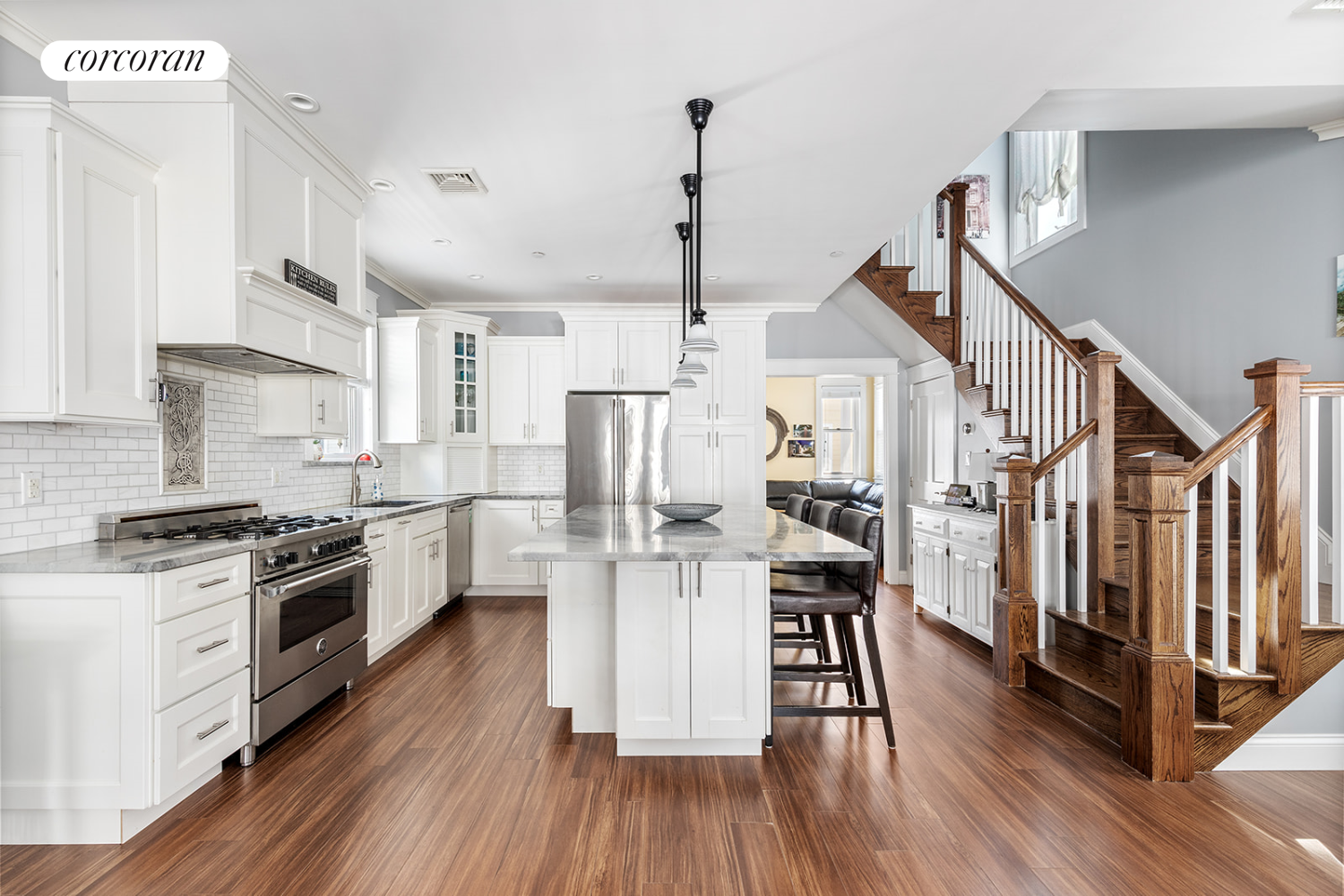 a kitchen with stainless steel appliances a white stove top oven and cabinets