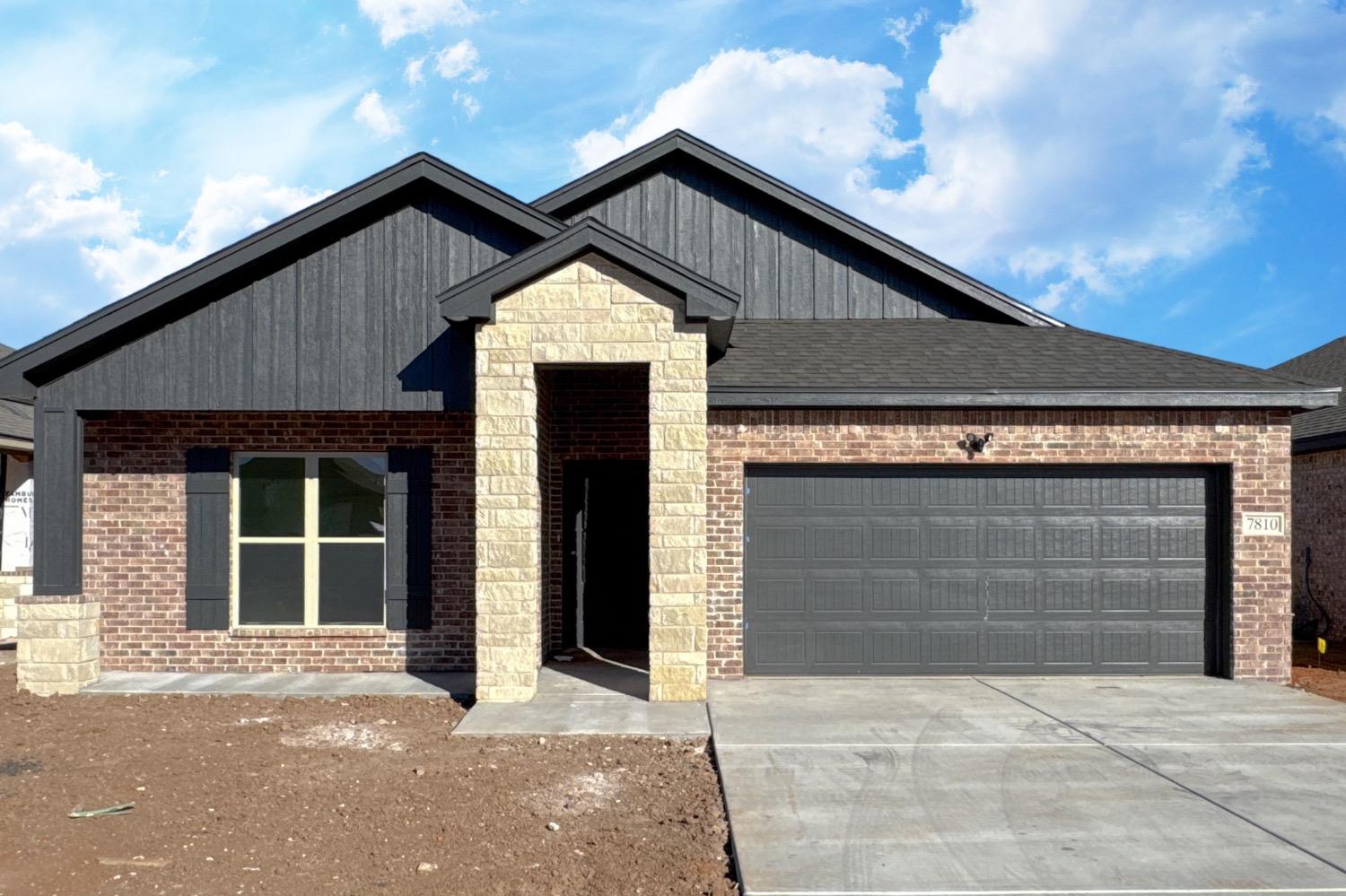 a front view of a house with garage