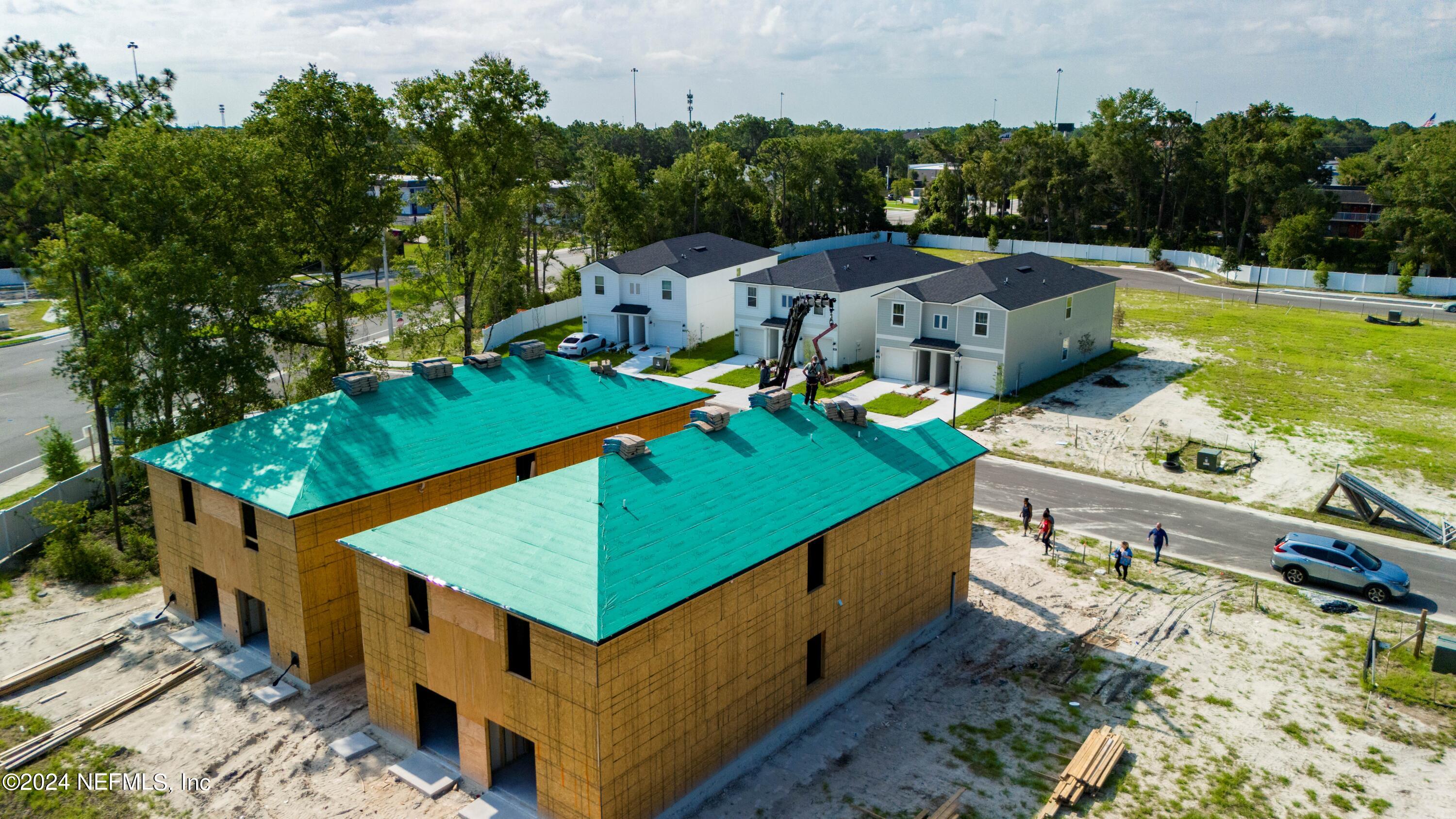 an aerial view of a house with a yard patio and swimming pool