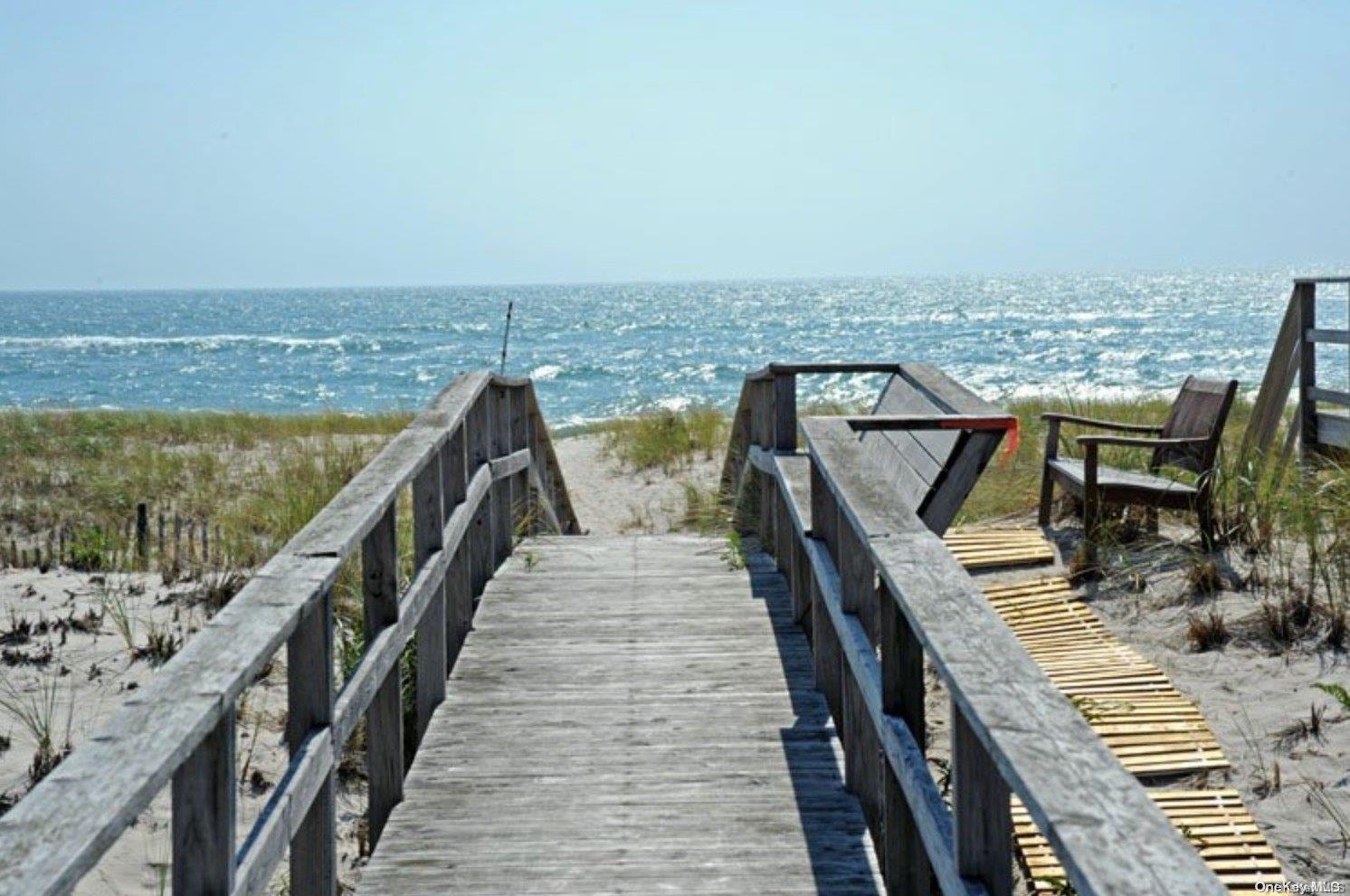 a view of roof deck with ocean view and wooden floor