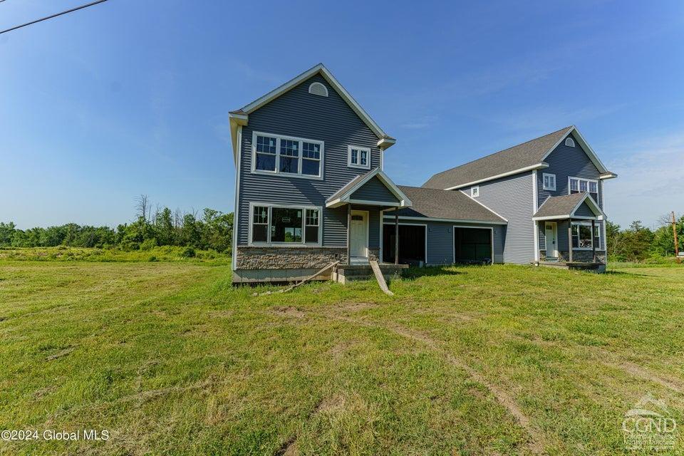 a front view of a house with a garden