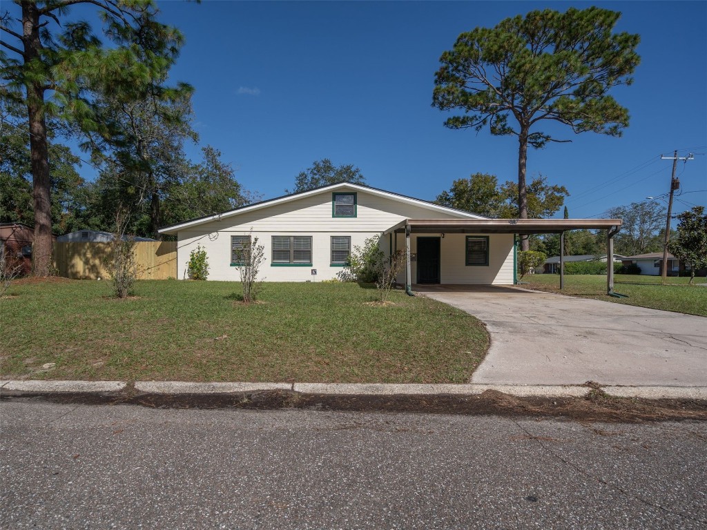 a front view of a house with a garden and trees