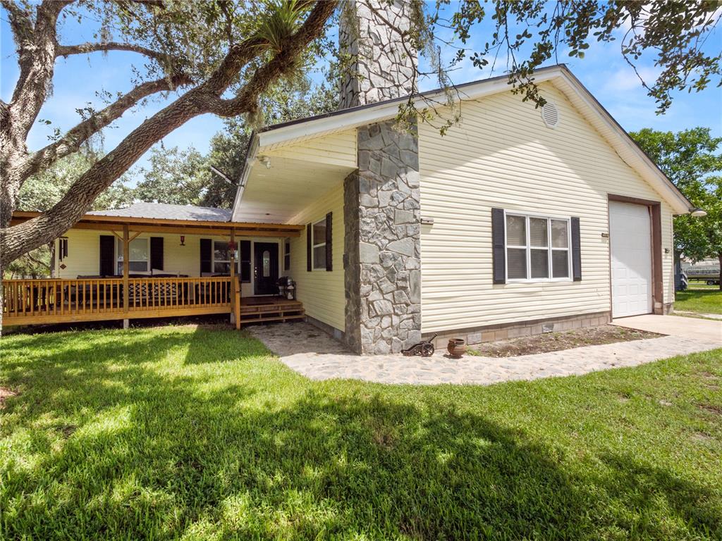 a view of a house with a backyard