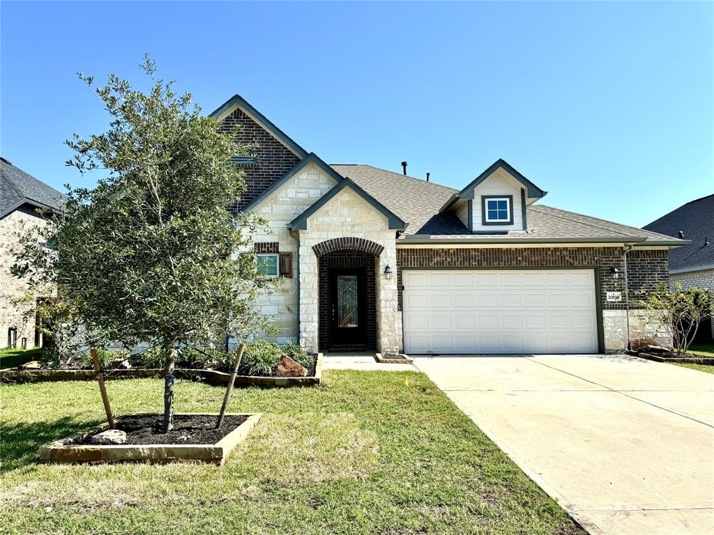 a front view of a house with a yard and garage