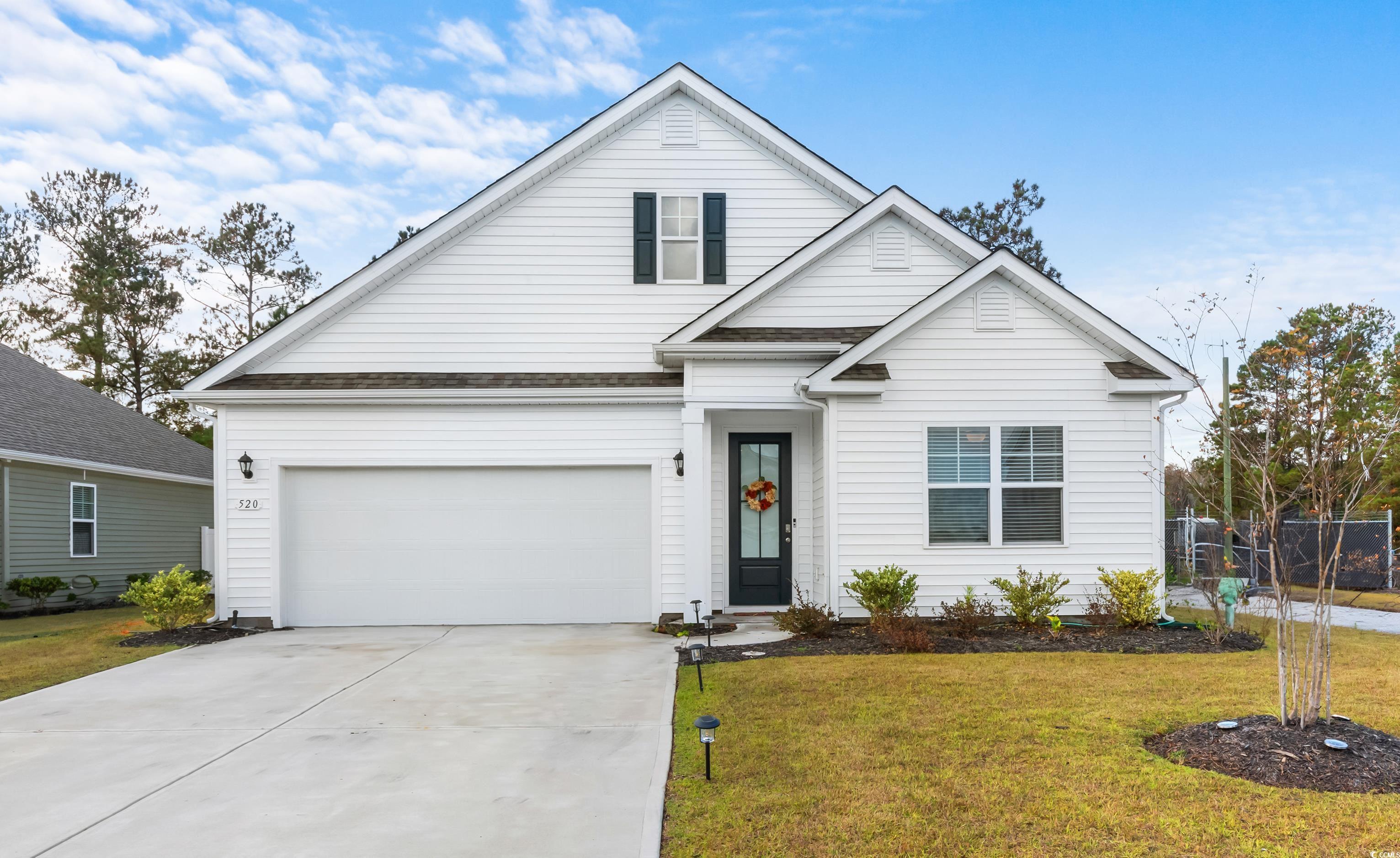 View of front of property featuring a garage and a