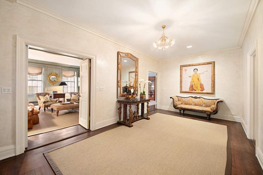 a bedroom with furniture and a large window