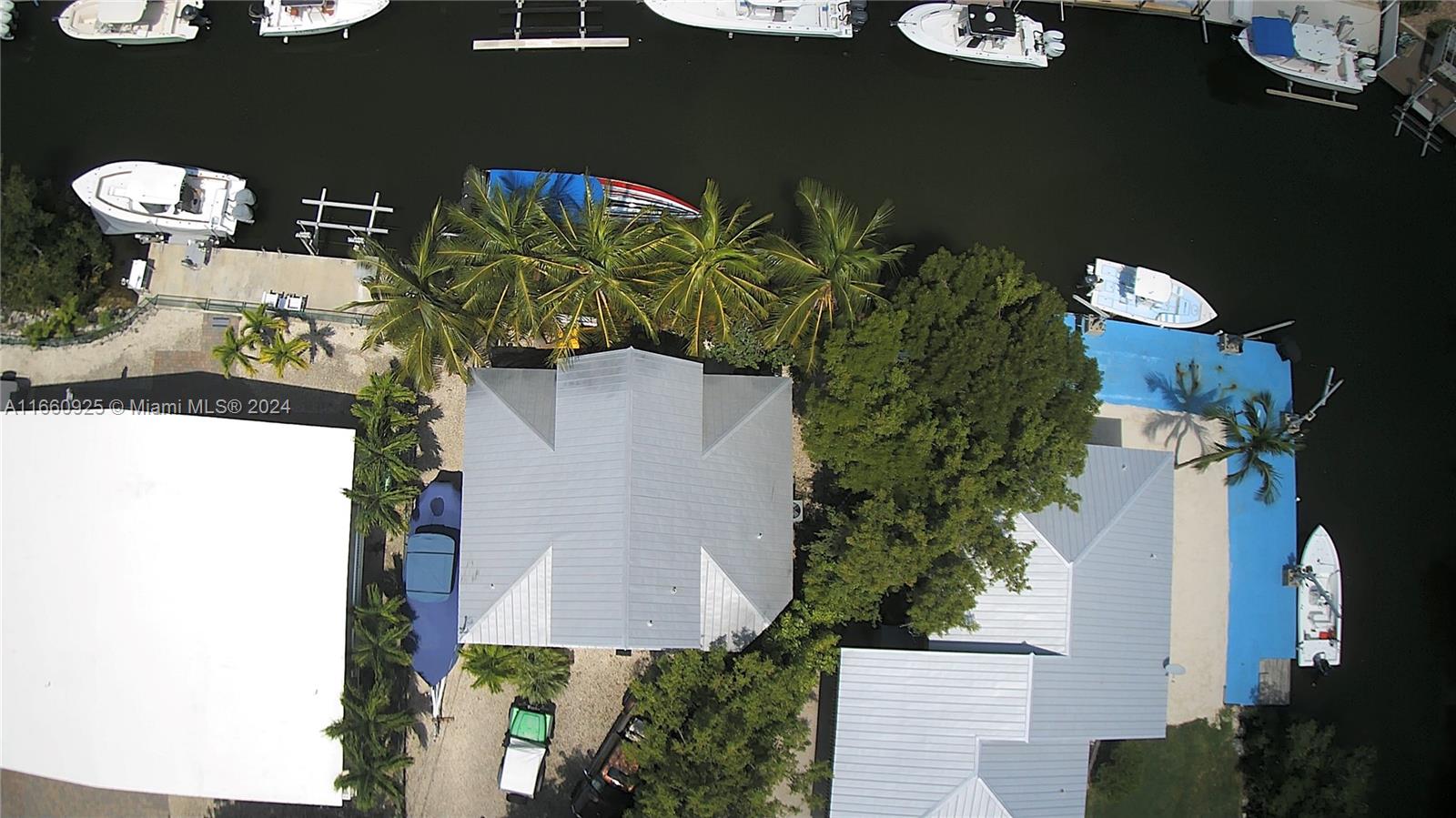 an aerial view of a house with table and chairs