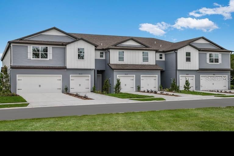 a front view of a house with a yard and garage