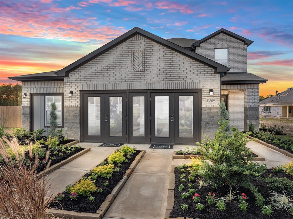 a front view of a house with a yard outdoor seating and mountain view