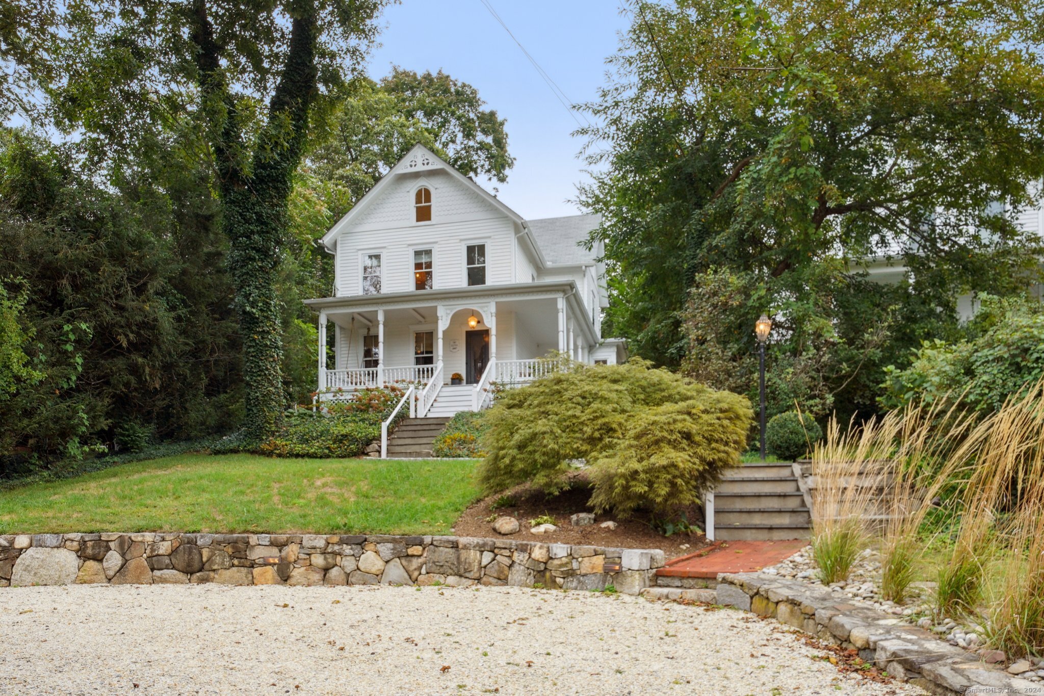 a view of a white house with a yard