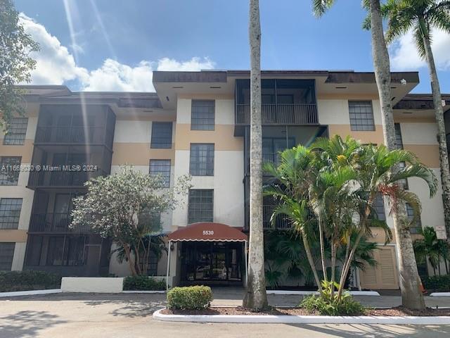 a front view of a building with palm tree