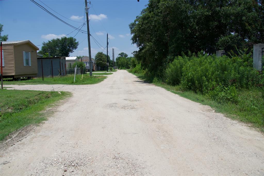 a view of a road with a big yard