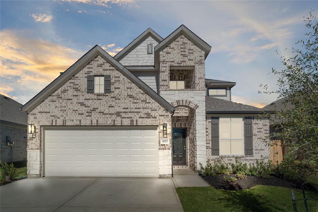 a front view of a house with garage