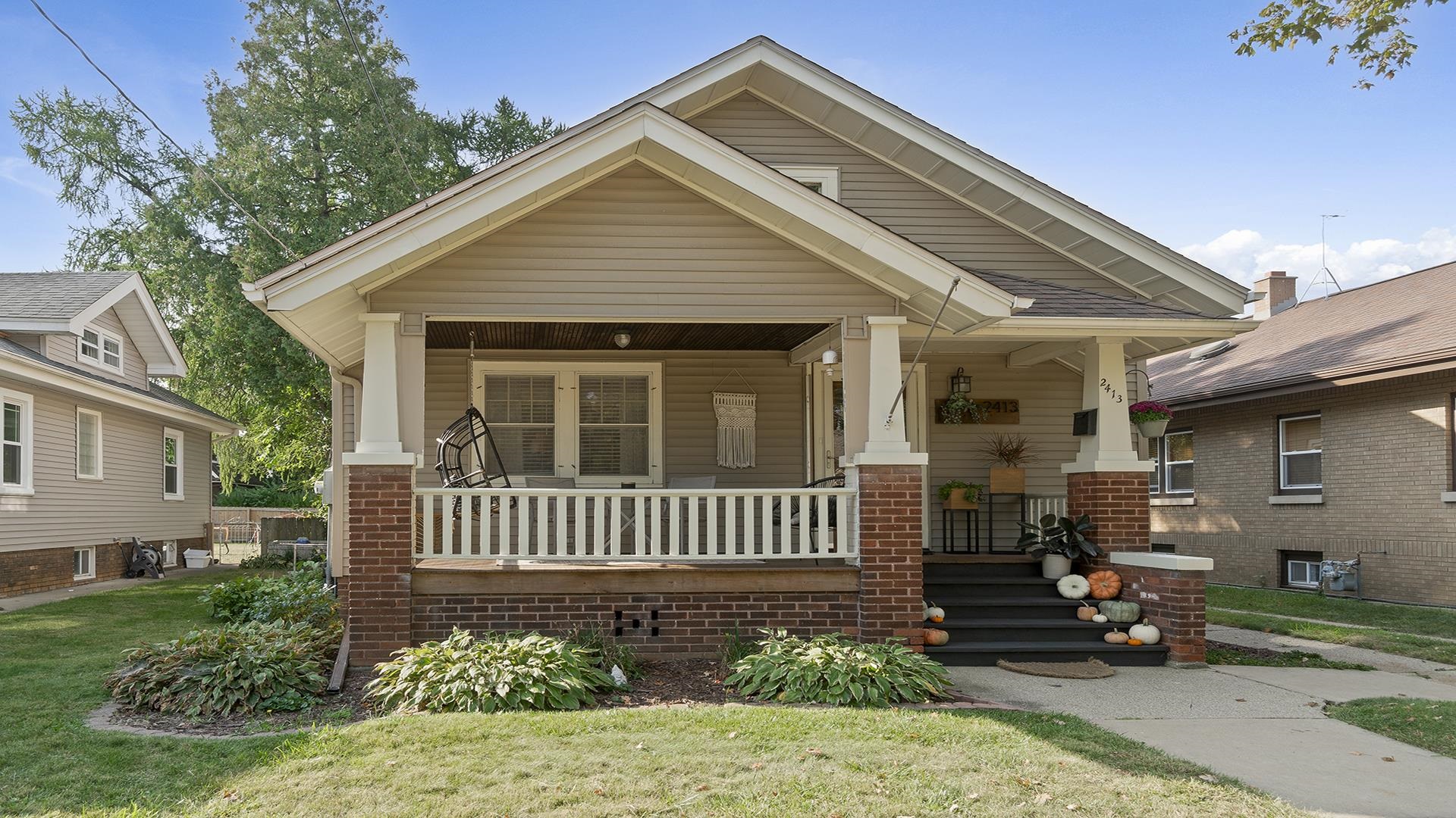 a front view of a house with a garden