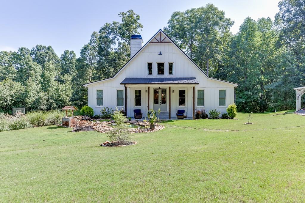 a front view of a house with a garden and porch