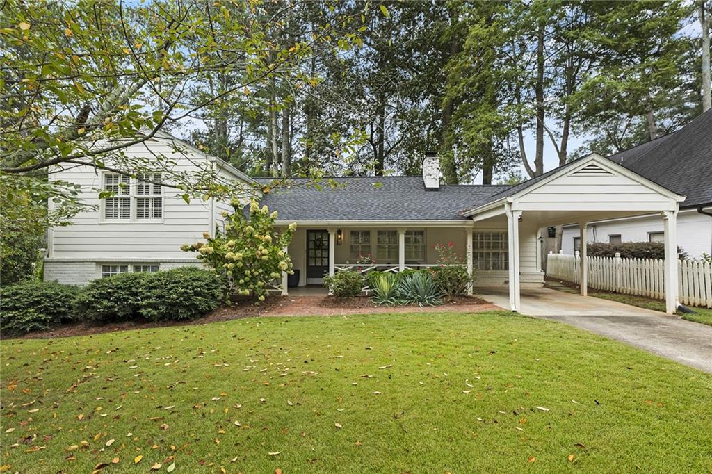 a front view of a house with a yard and porch