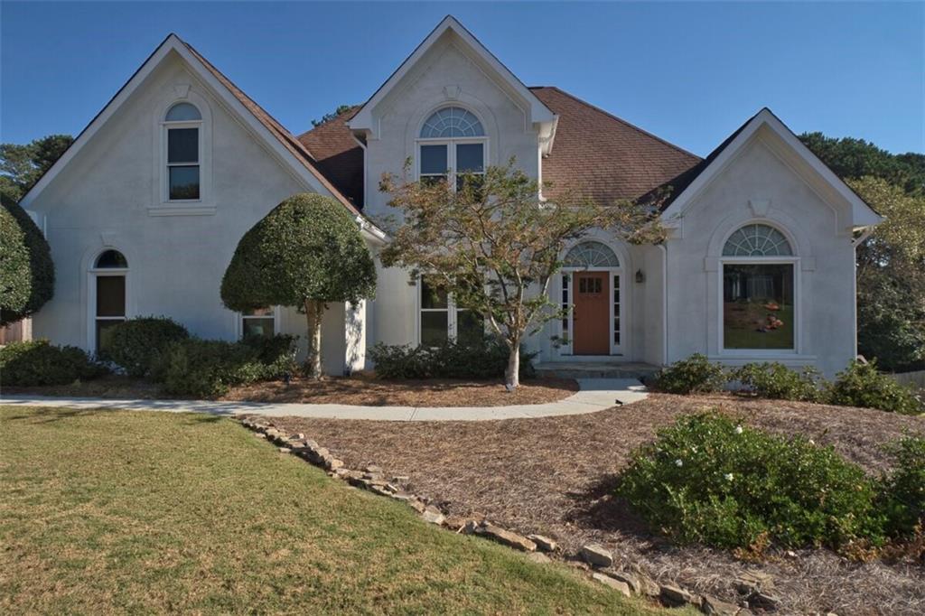 a front view of a house with garden