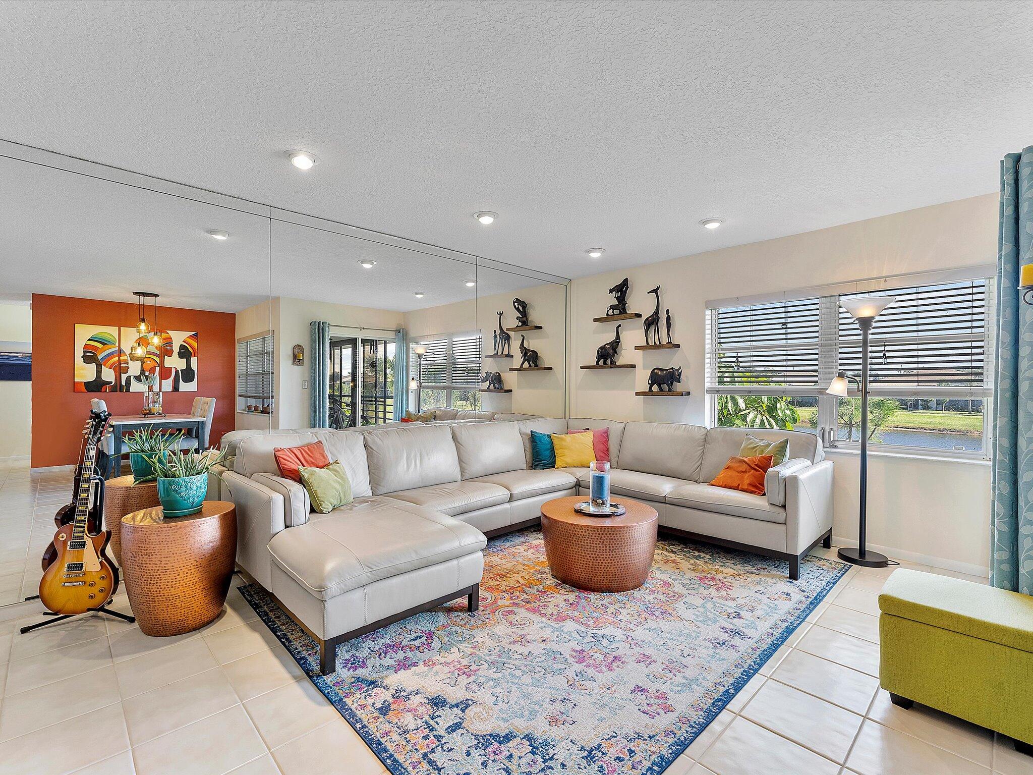 a living room with furniture a rug and a large window